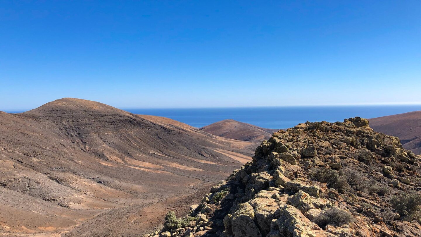 felsiger Grat mit Aussicht über das Barranco de los Canarios bis zum Meer - Fuerteventura