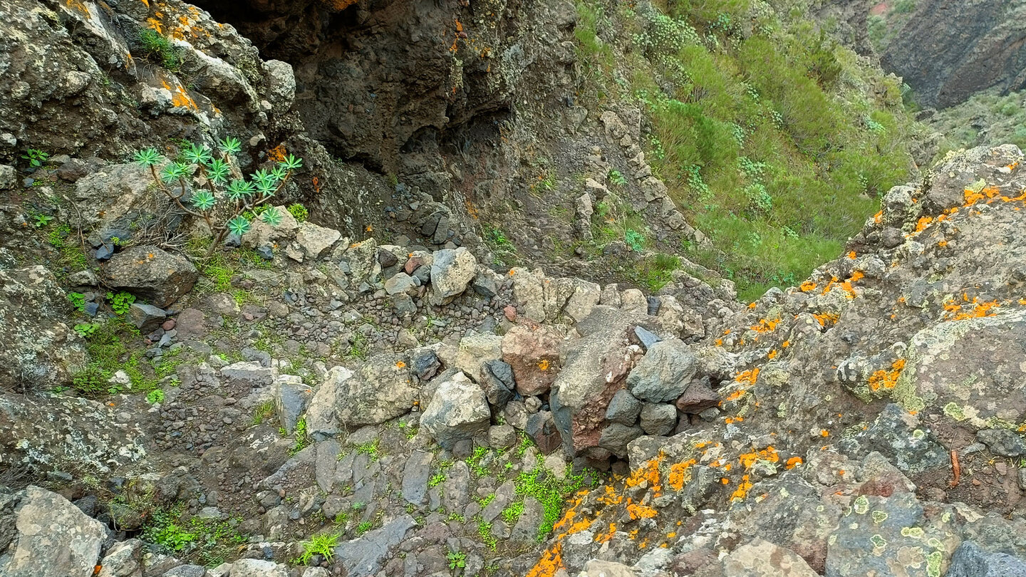 steiler Abschnitt des Wanderwegs mit Stützmauern und Serpentinen