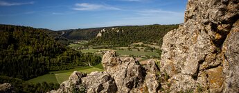 Aussicht über das Obere Donautal mit Schloss Werenwag auf dem Felsen, im Vordergrund verwitterter Kalkfelsen