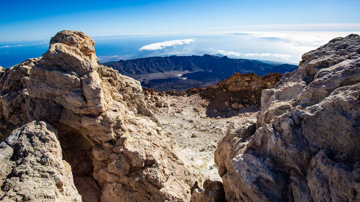 Blick auf die Caldera vom Pico del Teide durch Felsformationen | © Sunhikes